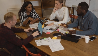 interracial group of people discussing at the table