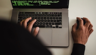 crop faceless programmer working on laptop in studio