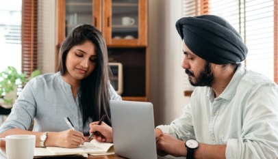 focused tutor and student doing homework assignment using laptop