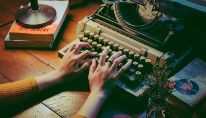 person using typewriter