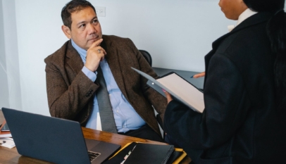 focused diverse coworkers discussing business project in office