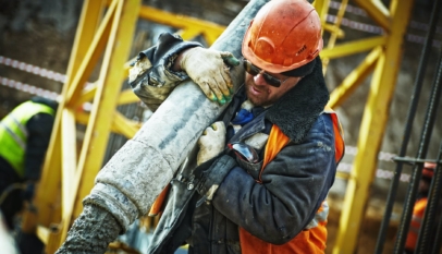 man carrying gray pipe