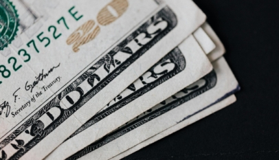 pile of american paper money on black surface