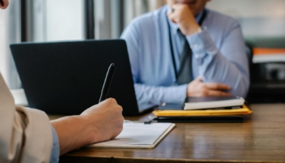 woman filling job application form in office with boss